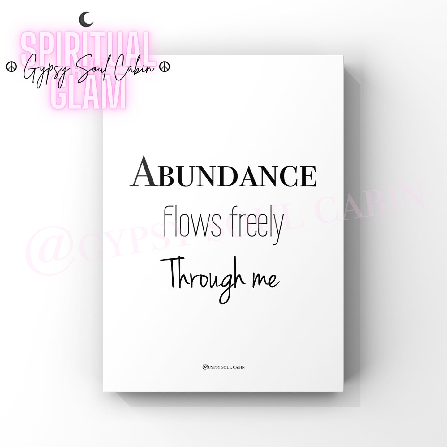 A black and white quote print with the text ‘Abundance Flows Freely Through Me’ on a white background, with a watermark that says 'Gypsy Soul Cabin’.