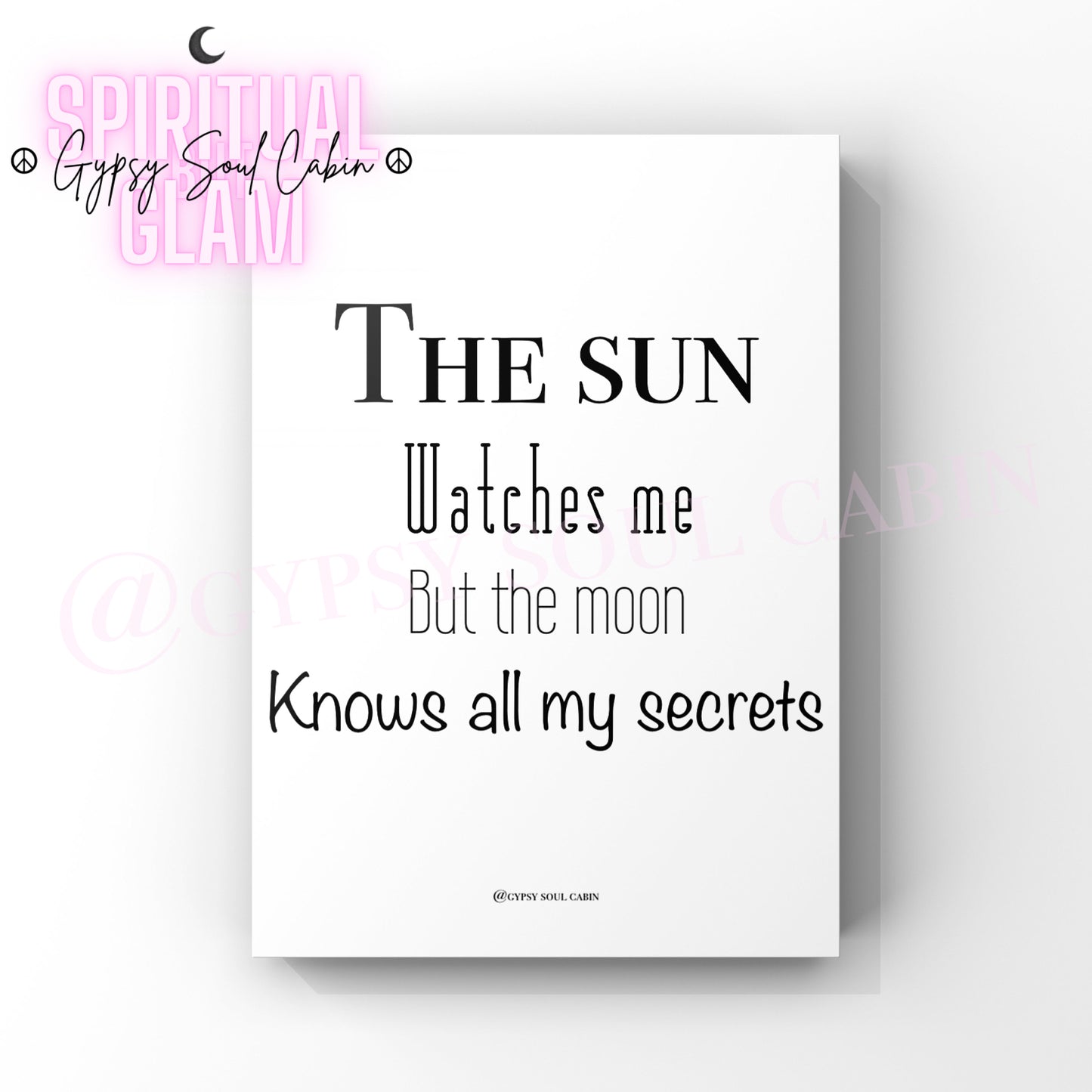 A black and white quote print with the text 'The Sun watches me but the Moon knows all my secrets' on a white background.