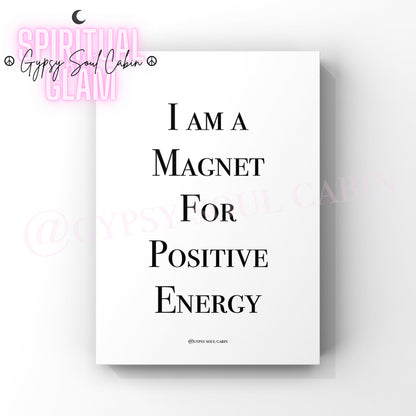 A white poster print with the text "I AM A MAGNET FOR POSITIVE ENERGY" in black writing.