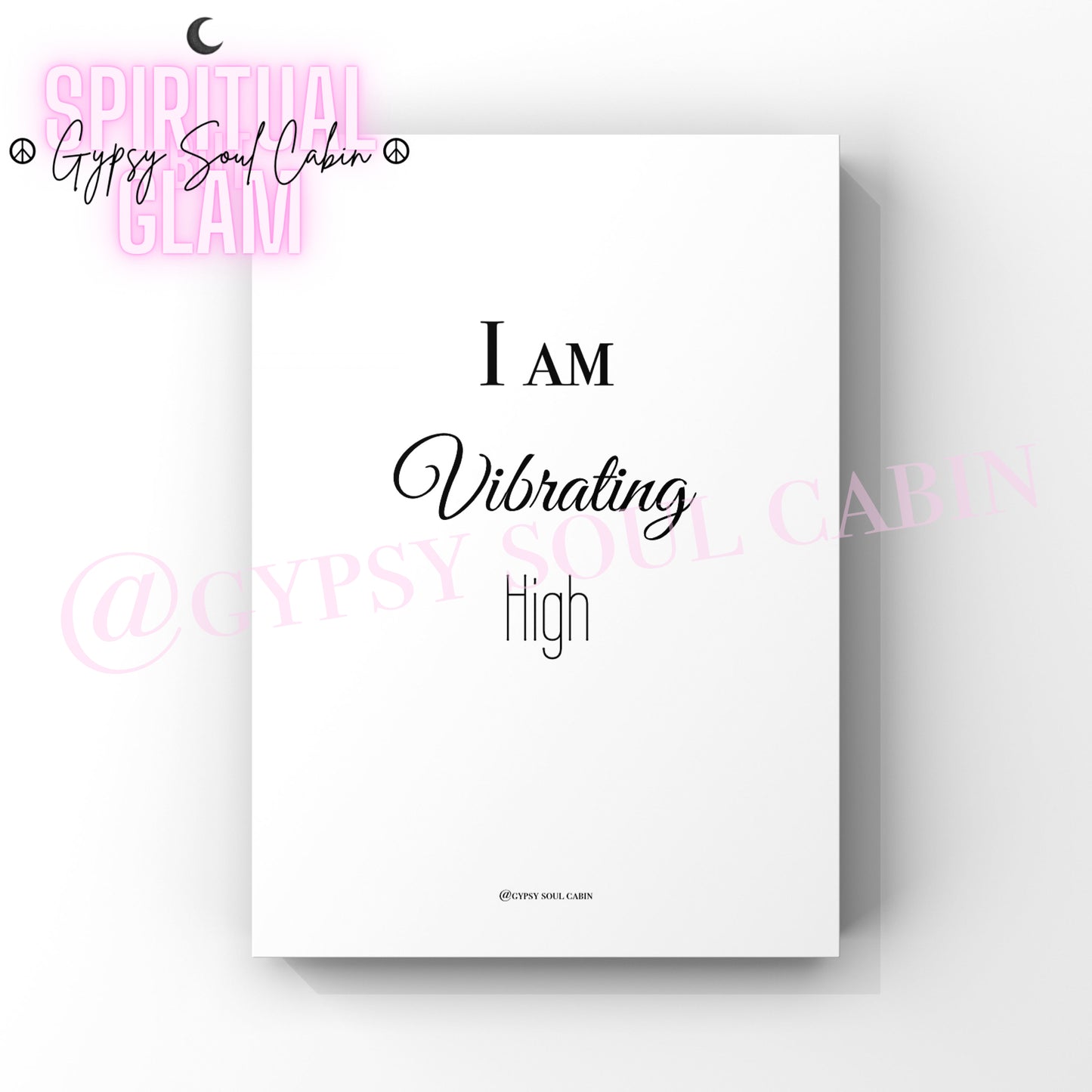 A black and white quote print with the text 'I AM VIBRATING AT A HIGH FREQUENCY' on a white background.