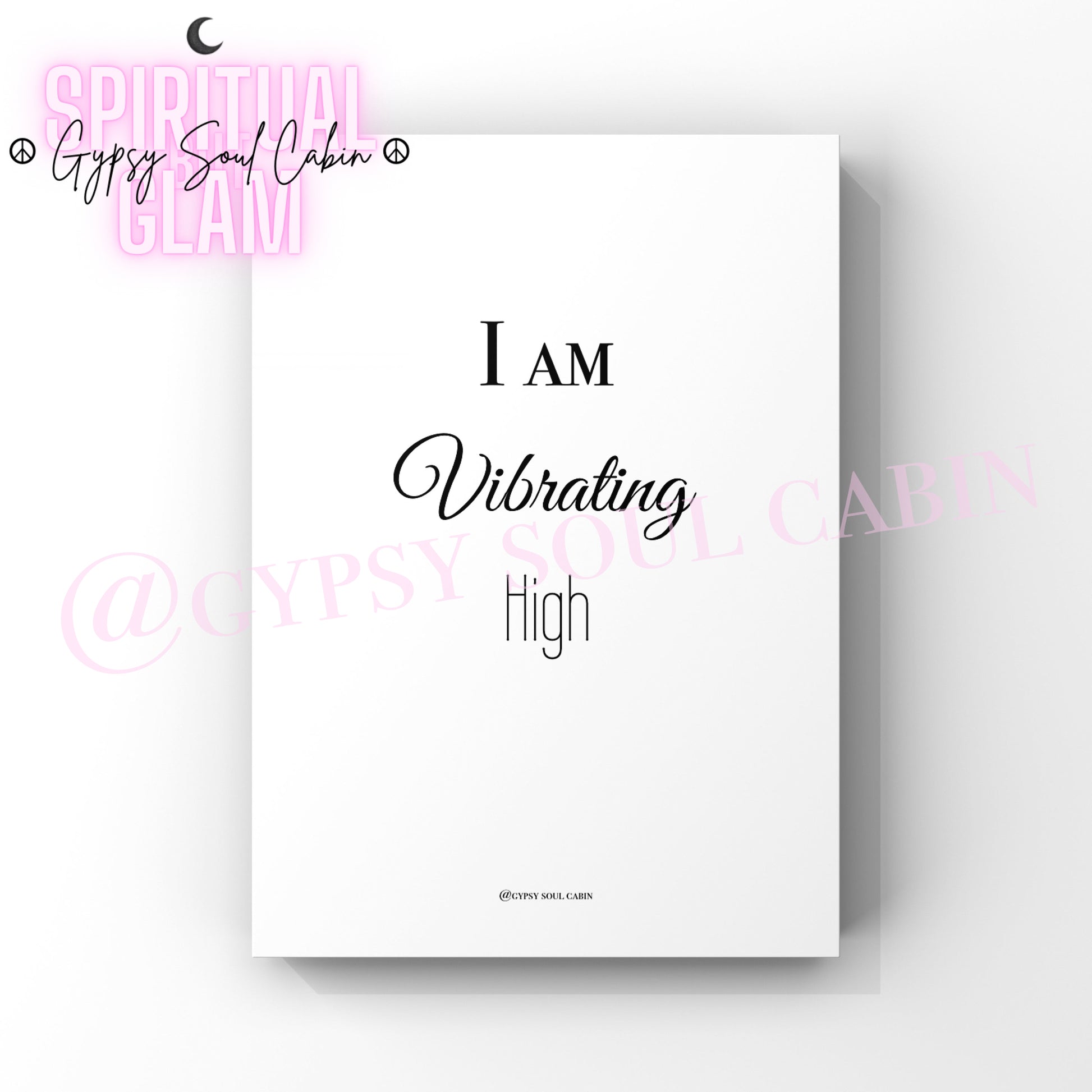 A black and white quote print with the text 'I AM VIBRATING AT A HIGH FREQUENCY' on a white background.