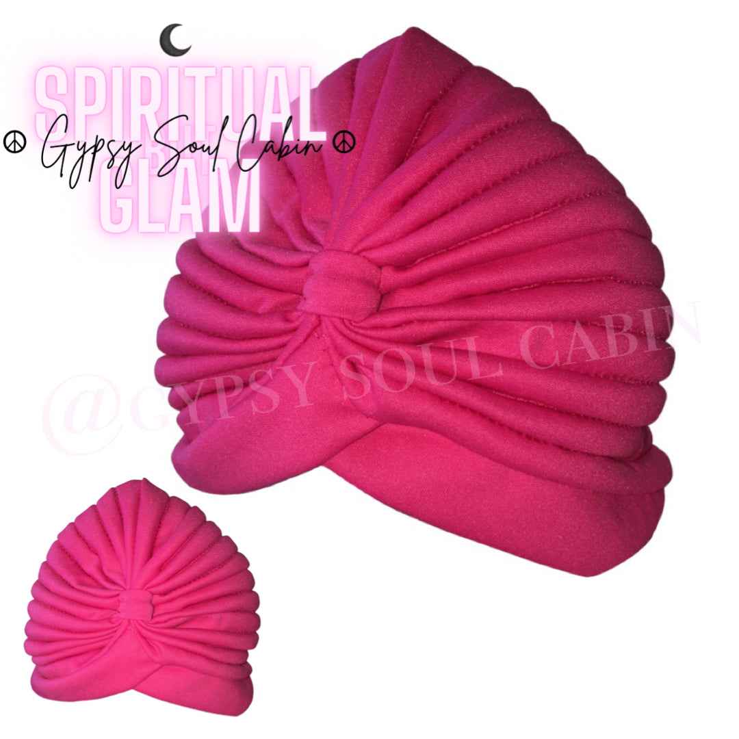 Showcasing two pink head wrap turbans on a fresh white background.