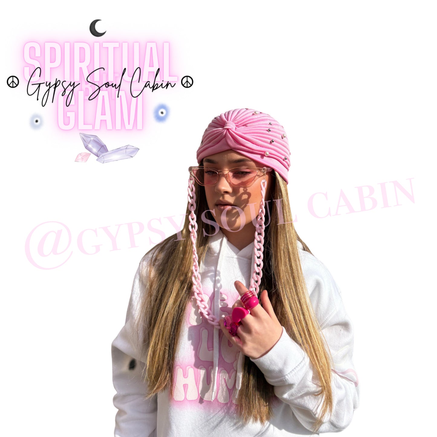 A pretty girl wearing a Gypsy Soul Cabin unique hoodie with pink accessories to match such as pink fashion glasses, pink fashion Y2T style rings and gypsy head wrap on a fresh white background.