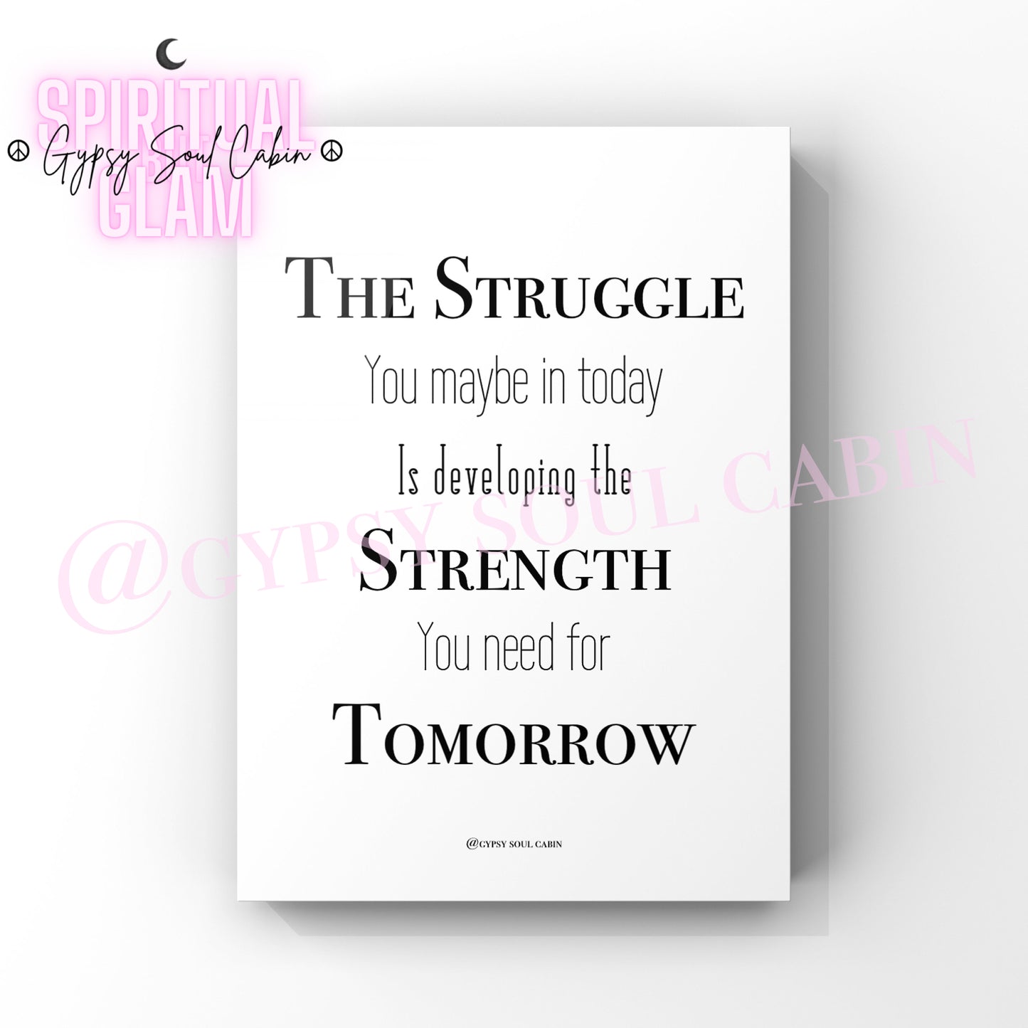 A black and white quote print with the text 'The Struggle You May Be In Today Is Developing The Strength You Need For Tomorrow' on a white background.