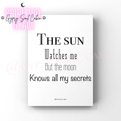 A black and white quote print with the text 'The Sun watches me but the Moon knows all my secrets' on a white background.