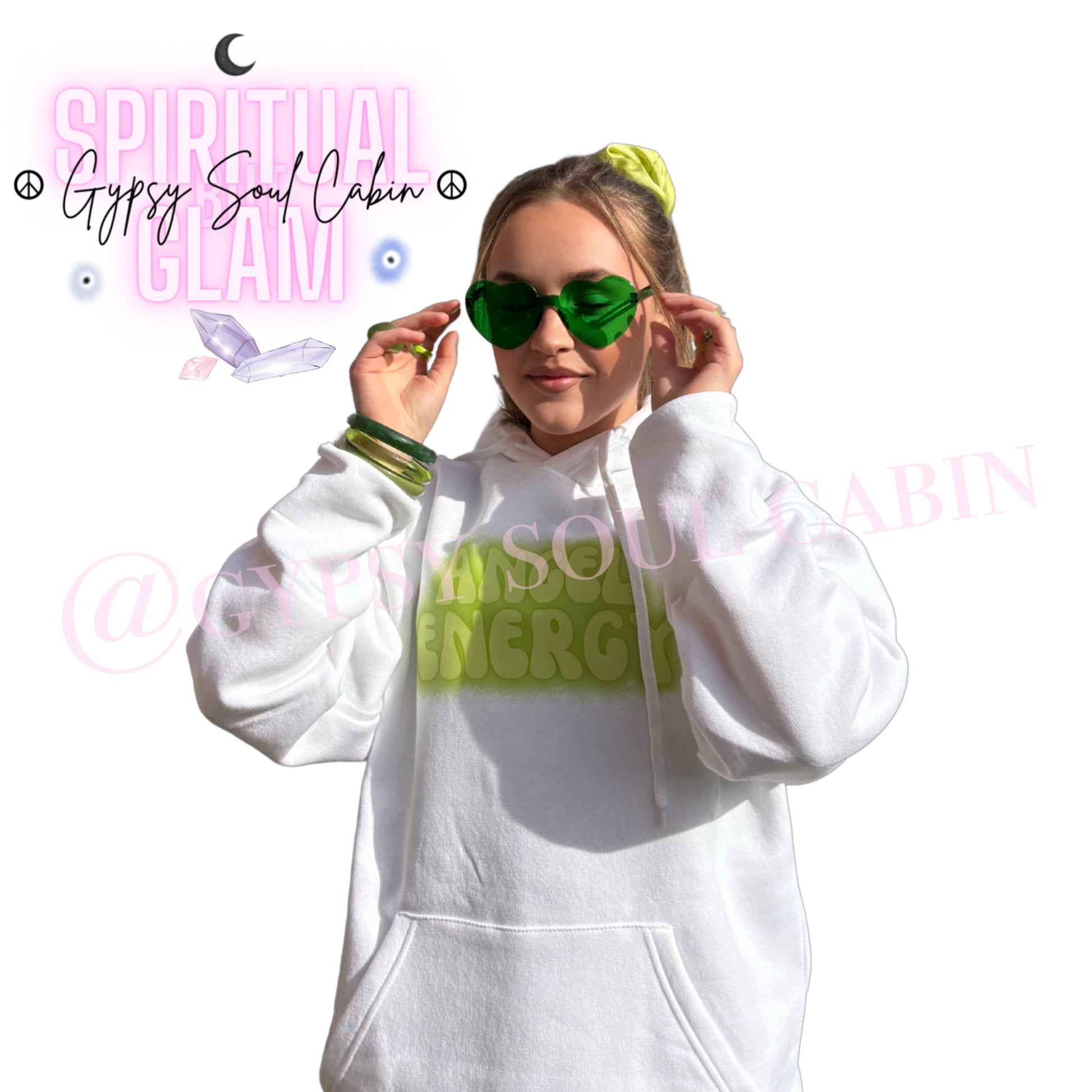 Model wearing translucent green heart-shaped fashion sunglasses paired with a white streetwear hoodie featuring a hand-designed green graphic print by Gypsy Soul Cabin.