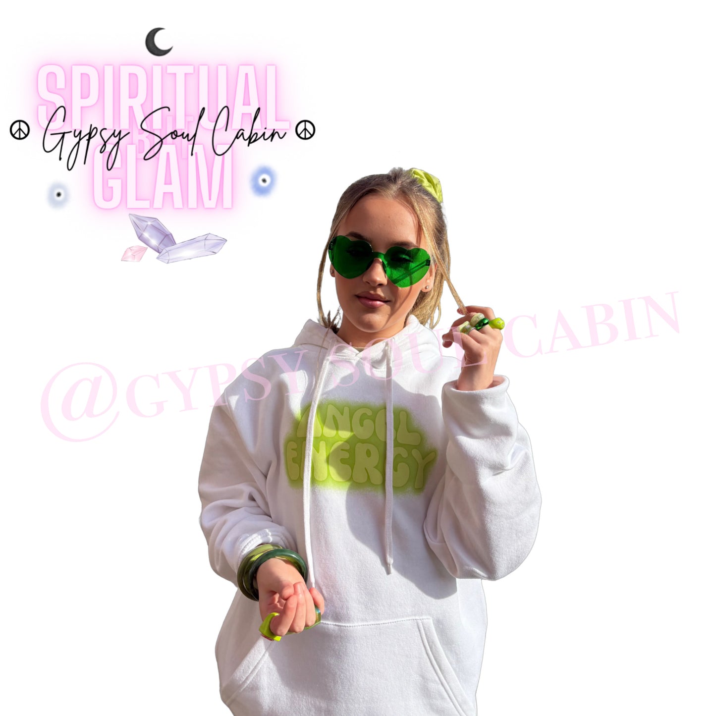 Model showcasing green heart-shaped glasses paired with matching green bangles, chunky rings, a hair scrunchie, and an Angel Energy hoodie by Gypsy Soul Cabin.