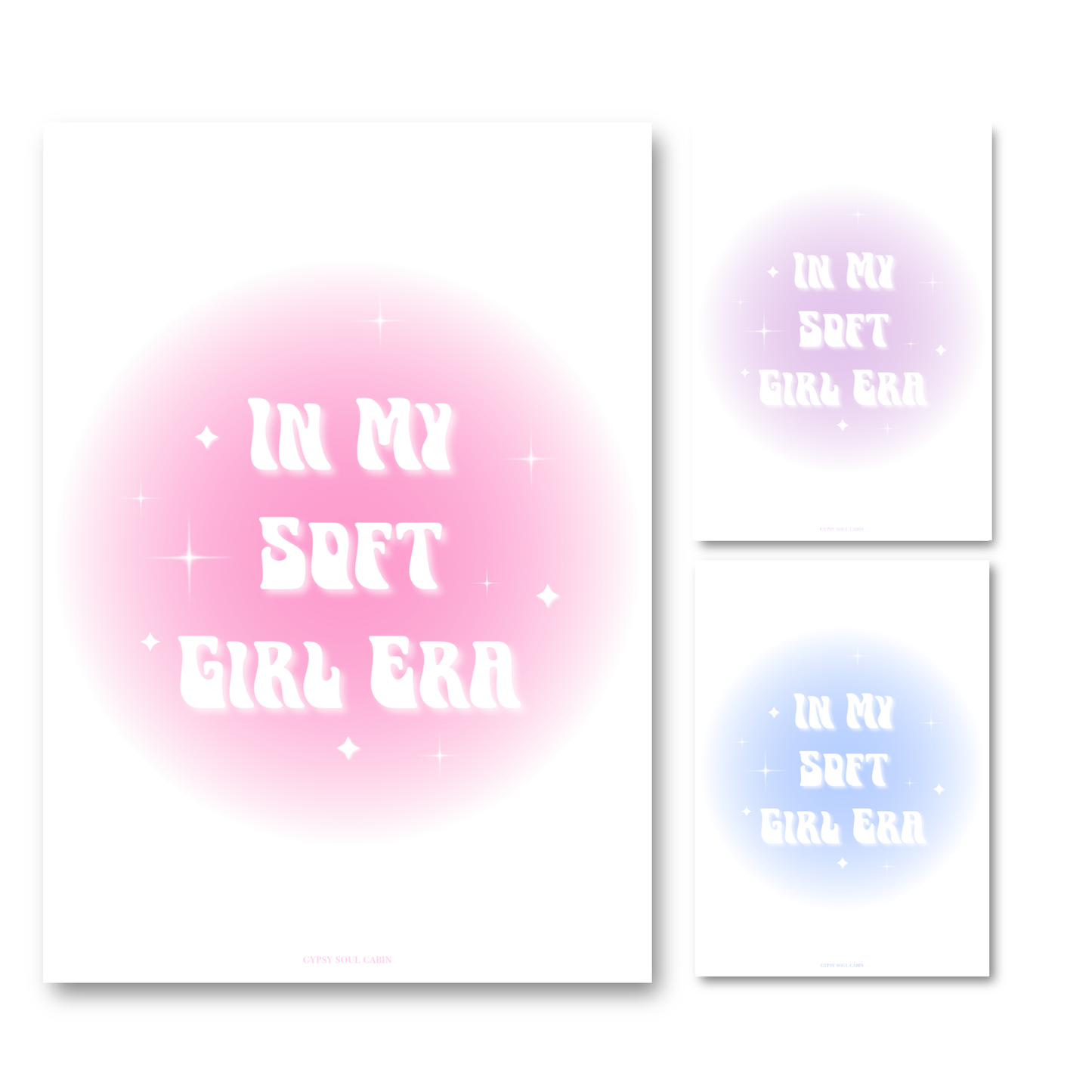 Gold-framed art prints leaning against a pink wall showcasing three colour options: pink, purple, and blue aura gradient glows with retro wavy text reading In My Soft Girl Era.