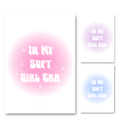 Gold-framed art prints leaning against a pink wall showcasing three colour options: pink, purple, and blue aura gradient glows with retro wavy text reading In My Soft Girl Era.