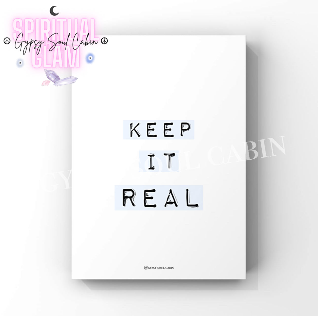 Clean office wall art print with the words “Keep It Real” printed in a bold label-maker stamp font across soft pastel blue-grey label tape backgrounds.