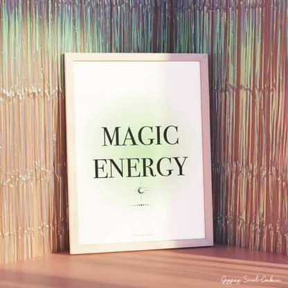 Minimalist green gradient aura typography print reading Magic Energy in a white frame displayed against a shimmering metallic fringe backdrop.