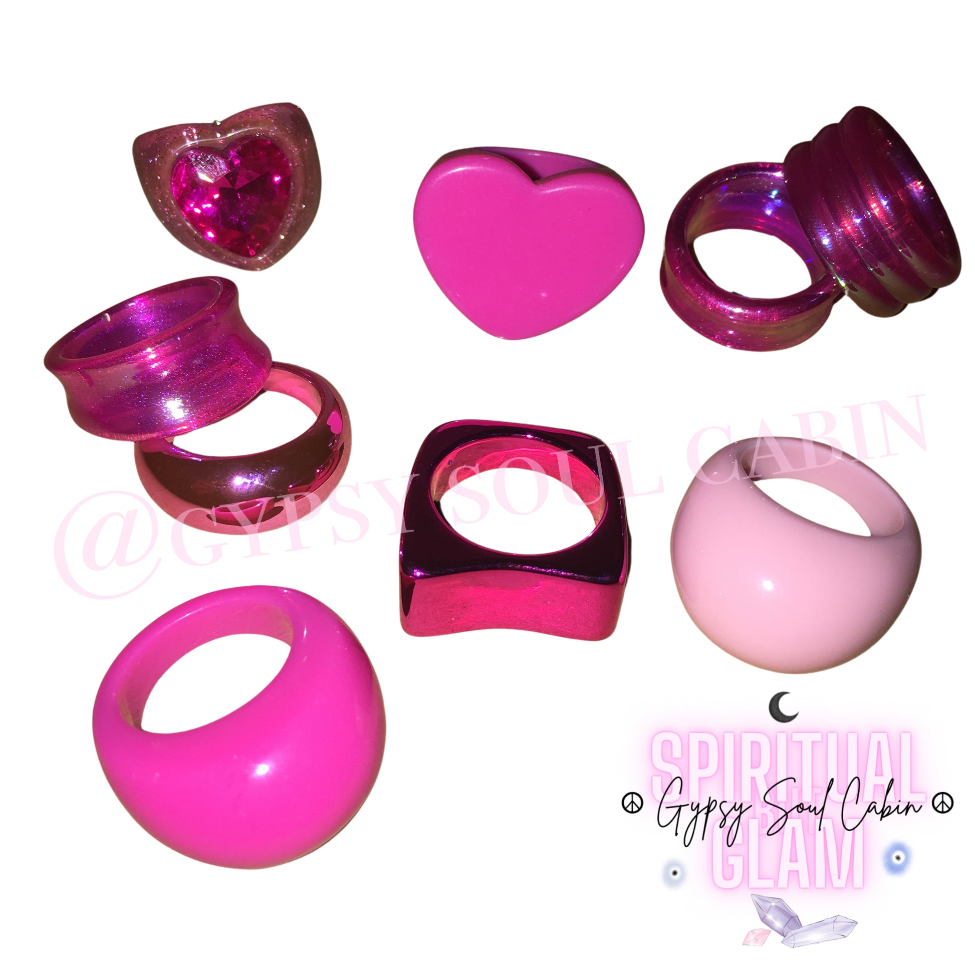 A collection of chunky pink Y2K retro fashion rings featuring metallic, glittery, heart-shaped, and pastel dome styles against a white background.