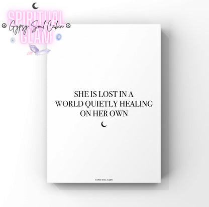 Minimalist mystical cosmic A4 typography print displaying the emotional quote She Is Lost In A World Quietly Healing On Her Own with a small black crescent moon symbol.